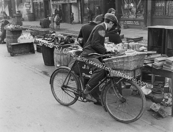 CICYCLIST AT STREET SIDE BOOK STALL